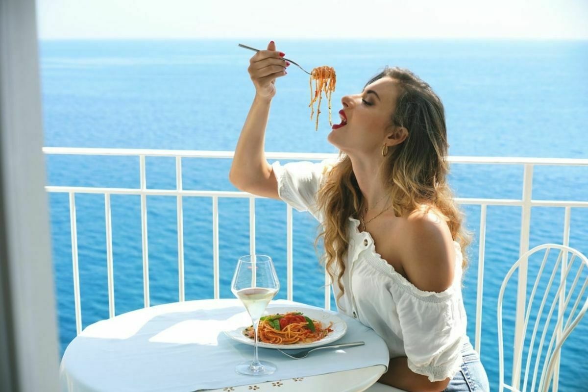 Young girl eats overlooking the Gulf of Sorrento